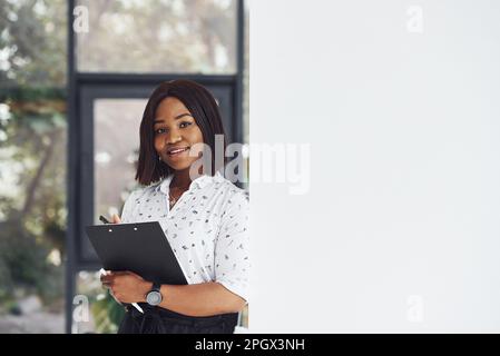 Young african american woman in formal clothes is in the office Stock Photo