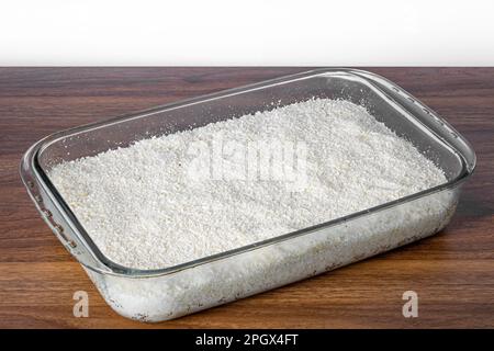 Couscous bowl, typical Brazilian dish, made with tapioca, milk, sugar and coconut milk. Perspective view. Stock Photo