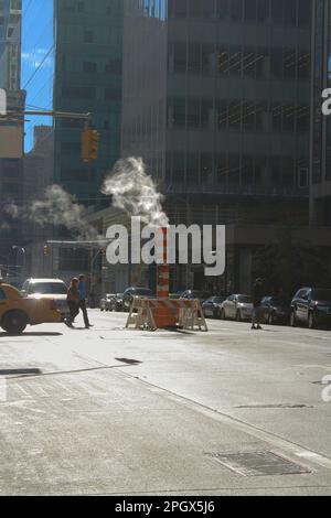 New York, NY, USA. October 19, 2014: Steam vapor being vented through a typical orange and white stack. Stock Photo