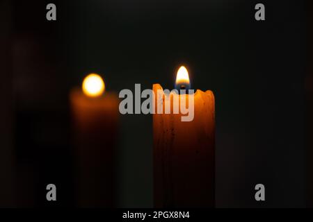 candle fire and back reflection of a candle in a mirror Stock Photo