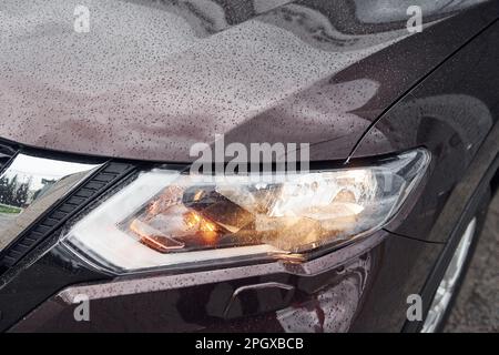 Front particle view of black modern automobile with headlights on Stock Photo