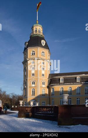 Karlsruhe, Germany - February 12, 2021:  Side of a tower with a flag at Karlsruhe Palace on a sunny winter day in Germany. Stock Photo