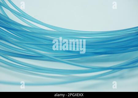 Abstract background, created by a blue nylon fishing line on a white backdrop Stock Photo
