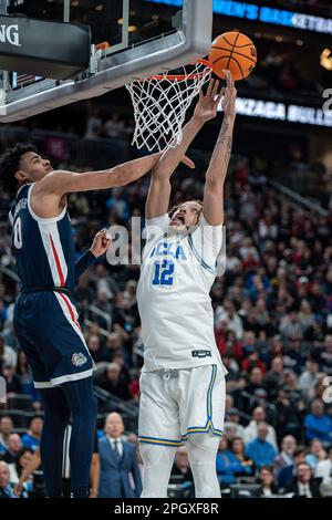 UCLA Bruins forward Mac Etienne (12) is fouled by Gonzaga Bulldogs guard Julian Strawther (0) during a NCAA men’s basketball tournament game, Monday, Stock Photo