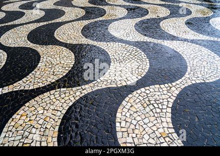 The black and white wave-shaped sidewalk pattern at Copacabana beach, Rio de Janeiro, Brazil. Stock Photo