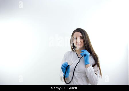 Happy young 30s beautiful physician doctor nurse supporting elderly mature retired patient sharing good news about health test results, feeling satisfied with disease treatment at checkup meeting Stock Photo