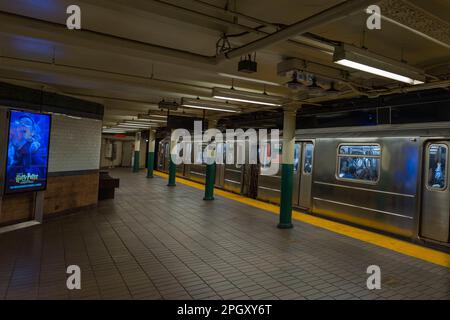 Close-up view of interior of New York subway station with train standing on platform. New York. USA. Stock Photo