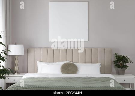 Blank canvas on wall in stylish bedroom interior. Space for design Stock Photo
