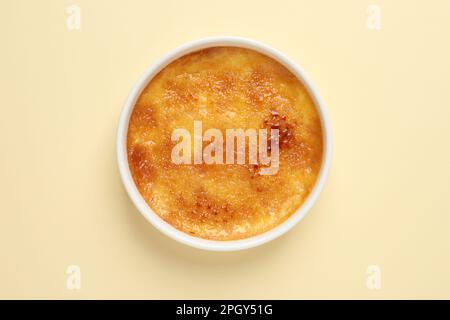 Delicious creme brulee on beige background, top view Stock Photo