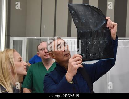 Lviv, Ukraine. 20th Mar, 2023. An American surgeon examines an X-ray of a patient in one of Lviv's hospitals. American specialists in plastic and maxillofacial surgery, cleft lip and palate, neurosurgeons, otolaryngologists, dermatologists, and urologists came to Lviv. Everyone who wanted to was able to sign up for appointments. Specialists consulted people with congenital and acquired defects, mine-explosive facial injuries and post-burn defects. Some patients underwent surgery after consultations. Credit: SOPA Images Limited/Alamy Live News Stock Photo