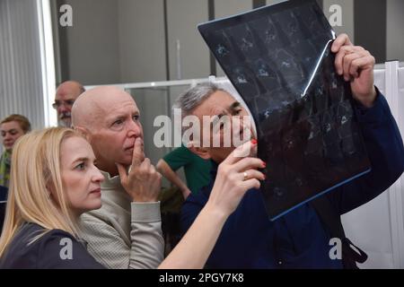 Lviv, Ukraine. 20th Mar, 2023. American surgeons examine an X-ray of a patient in one of Lviv's hospitals. American specialists in plastic and maxillofacial surgery, cleft lip and palate, neurosurgeons, otolaryngologists, dermatologists, and urologists came to Lviv. Everyone who wanted to was able to sign up for appointments. Specialists consulted people with congenital and acquired defects, mine-explosive facial injuries and post-burn defects. Some patients underwent surgery after consultations. (Credit Image: © Pavlo Palamarchuk/SOPA Images via ZUMA Press Wire) EDITORIAL USAGE ONLY! Not for Stock Photo