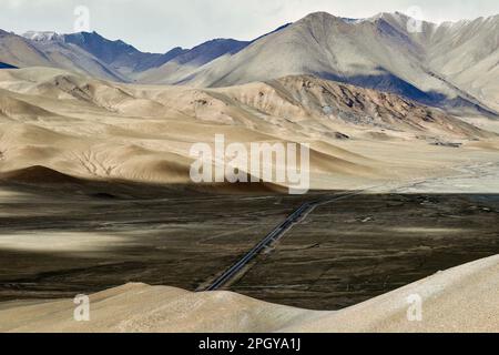 Looking up at Muztagh Tower, known as the father of glaciers, from Pamirs Karakul Lake Stock Photo