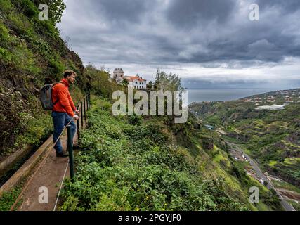 Hiker on footpath, Levada do Moinho, Ponta do Sol, Madeira, Portugal Stock Photo