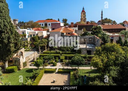 View of clock tower with gardens in front, Roloi, 7th century, Rhodes Town, Greece Stock Photo