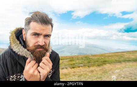 bearded man having moustache, banner. photo of bearded man in the mountain. Stock Photo