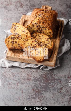 Homemade Chocolate Chip Pumpkin Bread Cut Into Slices closeup on the wooden board on the table. Vertical Stock Photo