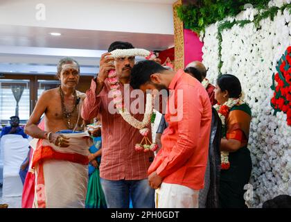 Father greeting the couple with a flower garland at the Engagement Party in Hotel Shaans, Trichy,Tamil Nadu,India Stock Photo