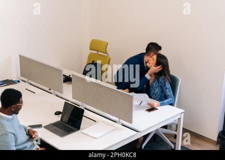 A greeting between two colleagues at work Stock Photo