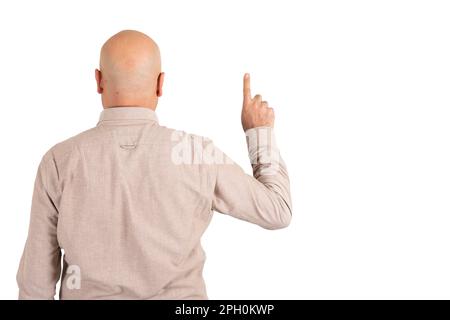 Caucasian bald man back view of pointing finger up. Pushing invisible button concept idea. Isolated white background, copy space. Stock Photo