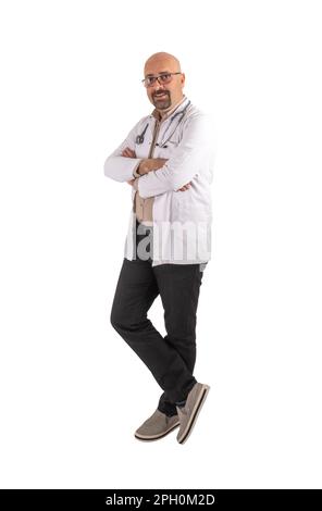 Trustworthy handsome bald middle aged full body shot male doctor. Isolated white background. Relax, smiling, confident physician wearing coat. Stock Photo