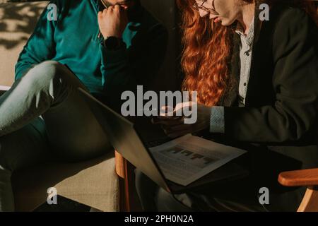 Business couple working together. Ginger businesswoman showing something on the phone to her good looking boyfriend Stock Photo