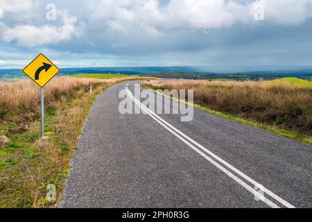 Turning road through Adelaide Hills farms during winter season, South Australia Stock Photo