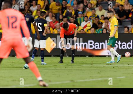 Referee, KIM Dae Yong marks a line for a penalty kick during the match between Australia and Ecuador at CommBank Stadium on March 24, 2023 in Sydney, Stock Photo