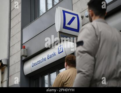 Berlin, Germany. 25th Mar, 2023. People walk past a Deutsche Bank branch in Beriln, Germany, March 25, 2023. The share prices of Germany's biggest lender Deutsche Bank (DB) plunged on Friday as concerns about the health of European banks are mounting in the wake of the collapse of banks in the United States. Credit: Ren Pengfei/Xinhua/Alamy Live News Stock Photo