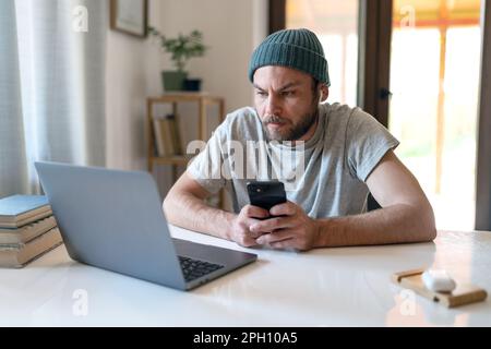 Modern man millennial using wireless portable devices at home. Stock Photo