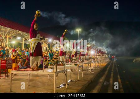 Tribeni Ghat, Rishikesh, Uttarakhand - 29th October 2018 : Ganga aarti being performed by Hindu priests to the chants of Vedic hymns. Crowded. Stock Photo