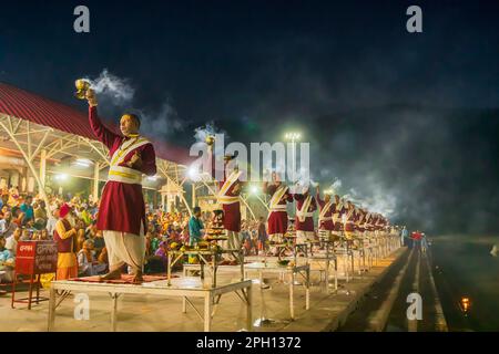 Tribeni Ghat, Rishikesh, Uttarakhand - 29th October 2018 : Ganga aarti being performed by Hindu priests to the chants of Vedic hymns. Crowded. Stock Photo