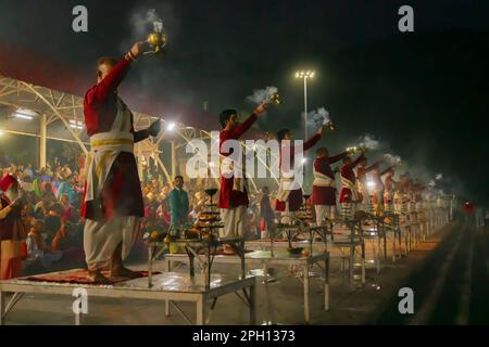 Tribeni Ghat, Rishikesh, Uttarakhand - 29th October 2018 : Ganga aarti being performed by Hindu priests to the chants of Vedic hymns. Crowded. Stock Photo