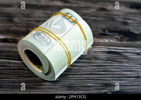 50 Piasters Half EGP LE Egyptian pound cash money bills rolled up with rubber bands with a image of Al Azhar mosque and Ramesses II the second 2nd, Eg Stock Photo