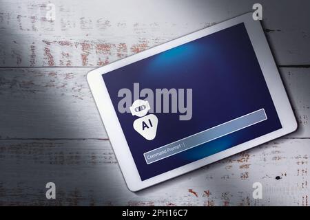 Top view of digital tablet with chatbot on screen and copy space. Command prompt AI concept. Artificial Intelligence. Futuristic technology. Stock Photo