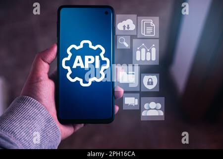 API concept with holographic smartphone interface. Application Programming Interface. Software Development. Stock Photo