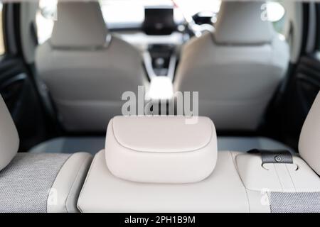 Shallow focus of rear headrest seen inside an empty car. Stock Photo