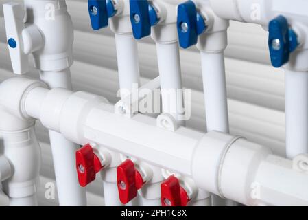 Pipeline of the heating system. Underfloor heating in construction. Pipefitter installing system of heating. Water floor heating system interior. Stock Photo