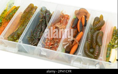 Jig silicone fishing lures in plastic lure box. Silicone fishing baits isolated. Colorful baits. Fishing spinning bait. Silicone soft plastic bait lur Stock Photo