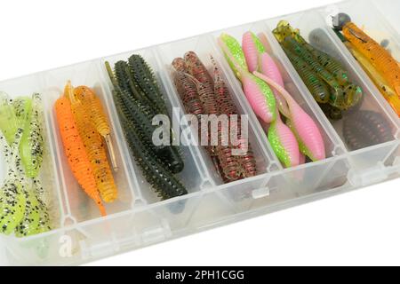 Jig silicone fishing lures in plastic tackle  lure box. Silicone fishing baits isolated. Colorful baits. Fishing spinning bait. Silicone soft plastic Stock Photo