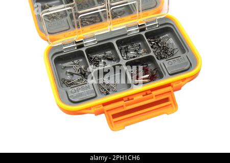 Opened tackle box with fishing hooks and accessories. Fishing hooks in box sections. Case for tackle elements. Fishing accessories background close-up Stock Photo