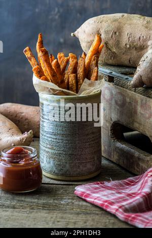 Sweet potato fries in clay dish. Close up, portrait. Stock Photo