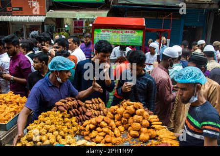 Bangladesh. 24th Mar, 2023. Bangladeshi vendors sell Iftar's items at Chawkbazar on the first day of the Muslim holy month of Ramadan. Every year a traditional Iftar market is open on this occasion for almost 400 years in Old Dhaka. (Photo by Md. Noor Hossain/Pacific Press) Credit: Pacific Press Media Production Corp./Alamy Live News Stock Photo