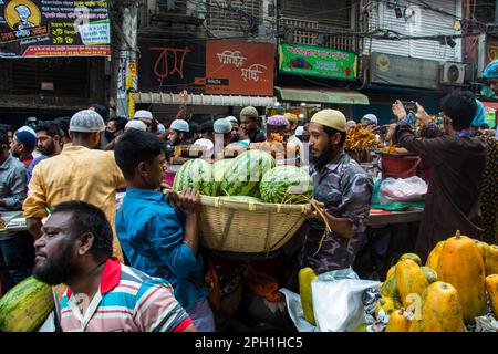 Bangladesh. 24th Mar, 2023. Bangladeshi vendors sell Iftar's items at Chawkbazar on the first day of the Muslim holy month of Ramadan. Every year a traditional Iftar market is open on this occasion for almost 400 years in Old Dhaka. (Photo by Md. Noor Hossain/Pacific Press) Credit: Pacific Press Media Production Corp./Alamy Live News Stock Photo