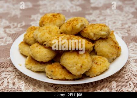 Fresh meat cutlets on a white plate on a table with a tablecloth. Stock Photo