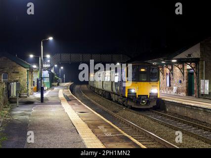 Northern Rail class 150 DMU train calling at the small 2 platform Whaley Bridge railway station, Derbyshire at night. Stock Photo