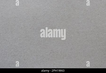 Gray recycled carton sheet background. Paper texture with fibers. Stock Photo