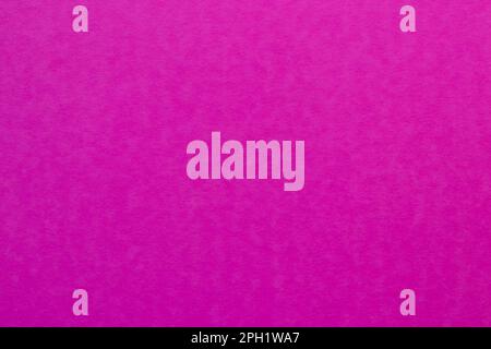 Fuchsia colored tinted paper sheet background. Purplish red color shade. Stock Photo