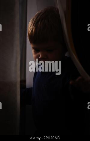 Two children behind window Stock Photo - Alamy