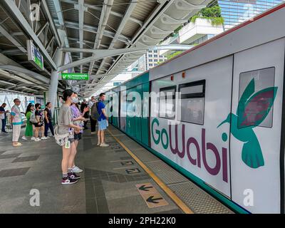 Bangkok, Thailand, Sky Train, Elevated Metro, Public Transportation in City Center Traveling to Station, Thai Advertising on Train Stock Photo