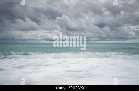 Windy waves crashing on a coast on a stormy day in winter. Stock Photo